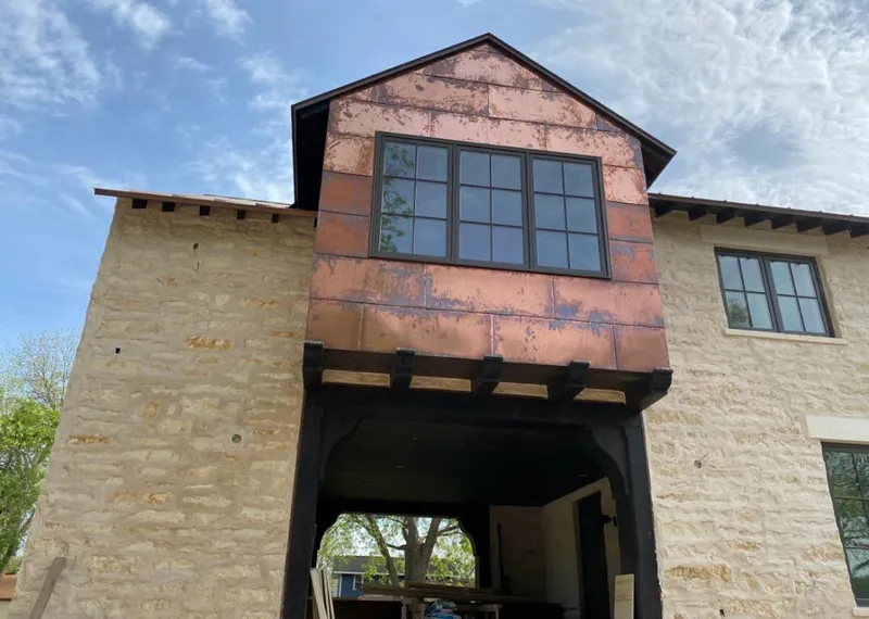Copper metal panel facade on a stone building for Roof Repair in Heber Springs