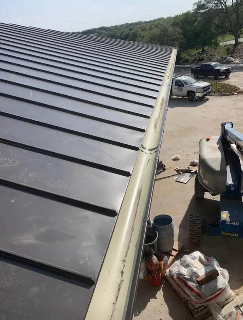 Standing seam panel and gutter detail on a metal roofing jobsite in Heber Springs
